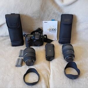 Nikon D300 DSLR camera body bundled with a Sigma lens and accessories